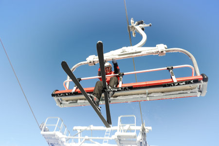 Ski lift carrying skiers.の写真素材
