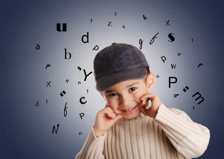 boy with denim cap, letters of alphabet on backgroundの写真素材