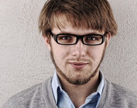 Young confident blond guy with glasses