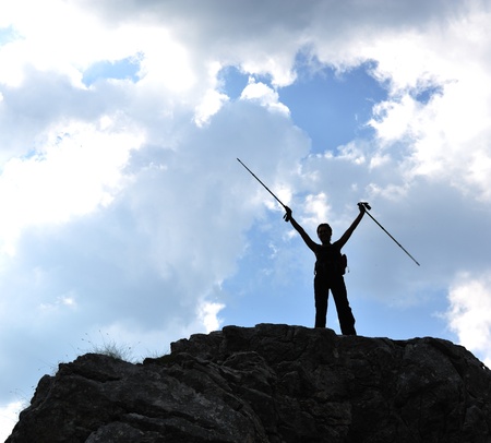 Silhouette of a woman during and adventage climbing and mountain walkingの写真素材