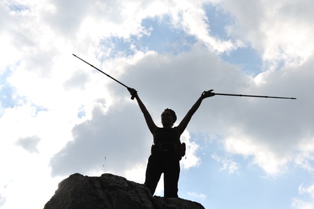 Silhouette of a woman during and adventage climbing and mountain walkingの写真素材