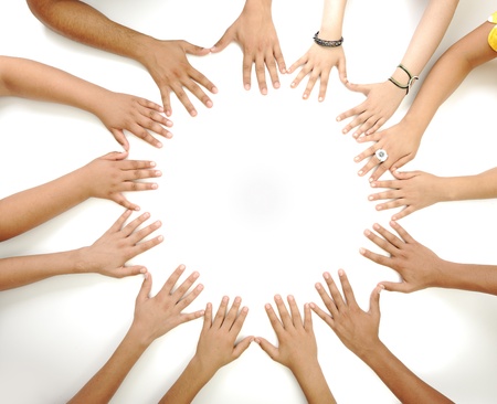 Conceptual symbol of multiracial children hands making a circle on white background with a copy space in the middle Conceptual symbol of multiracial children hands making a circle on white background with a copy space in the middle