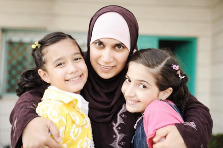 Muslim arabic mother with two daughters, love and careの写真素材