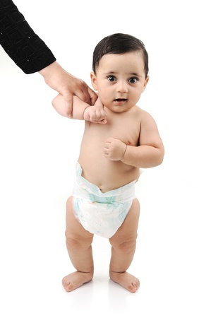 Cute baby isolated on white background, learning walking with his motherの写真素材