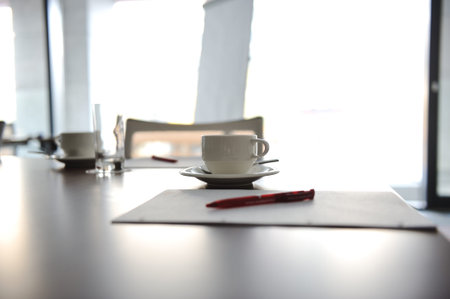 Cup of coffee on table in the conference room