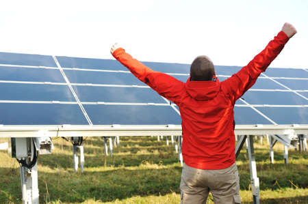 Success, engineer in solar panel fields opening arms upの写真素材