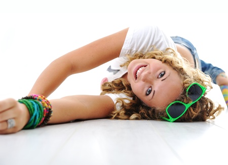 Teen cute girl with curly hair lying on floorの写真素材