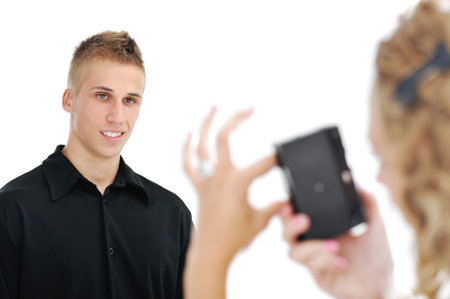 Girlfriend taking picture of happy smiling boyfriend