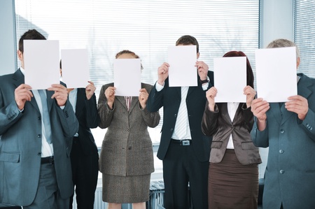 Business team holding white papers in officeの写真素材