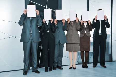 Successful business team standing holding white papersの写真素材