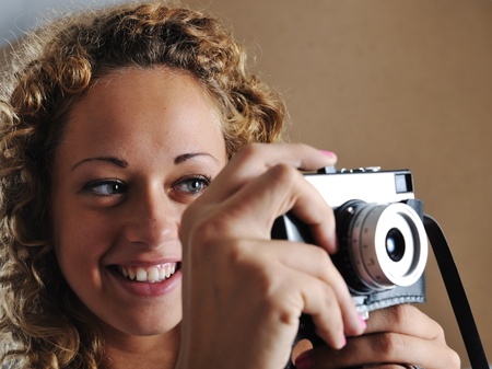 Blonde girl with retro cameraの写真素材
