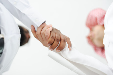 Closeup of business people shaking hands over a deal somewhere in the Middle east