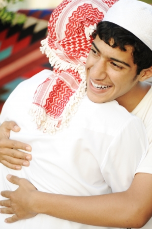 Friendly hug, two arabic guysの写真素材