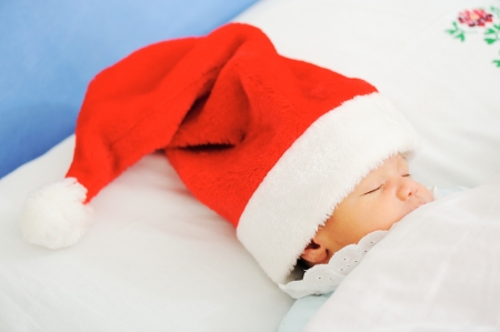 Newborn santa sleepingの写真素材