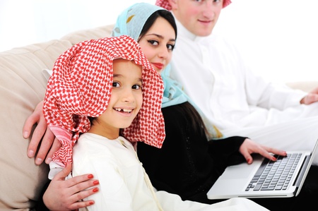 Parents and little boy at home with laptop computerの写真素材