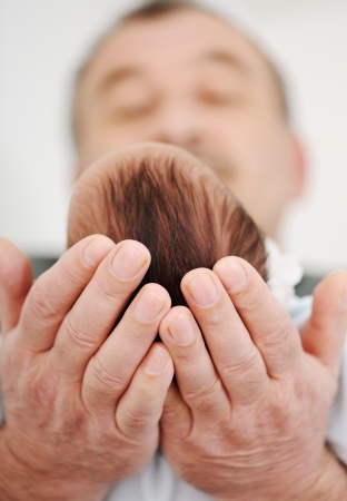 Father holding a beautiful newborn baby boyの写真素材
