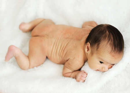 Newborn baby in hospital on bedの写真素材