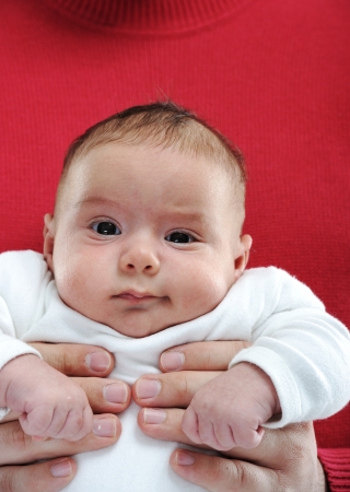 Newborn baby held by his fatherの写真素材