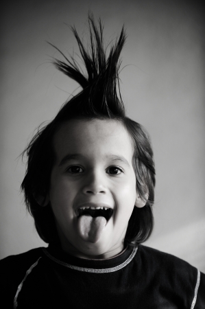 Portrait of kid with funny hair and tongueの写真素材