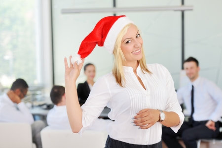 Santa girl businesswoman at office with colleaguesの写真素材