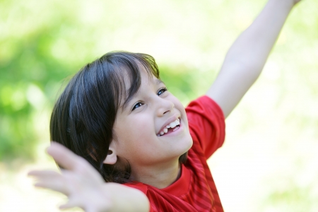 Closeup portrait of a little happy boy outsideの写真素材