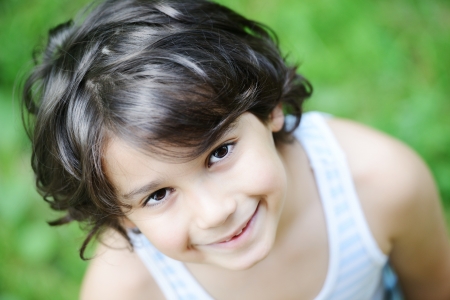 Closeup portrait of a little happy boy outsideの写真素材