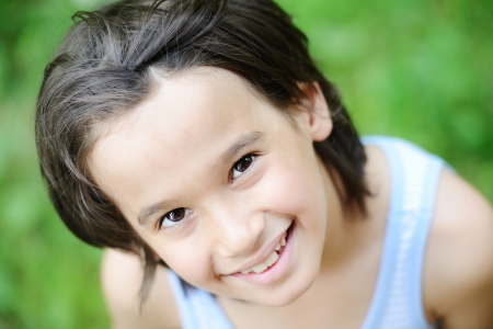 Closeup portrait of a little happy boy outsideの写真素材