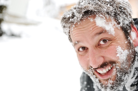 Man in snow, face closeup funの写真素材