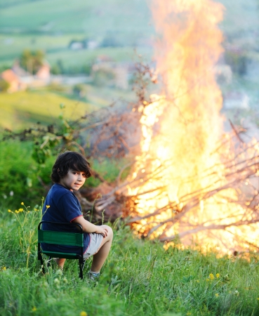 Kid beside the big fireの写真素材