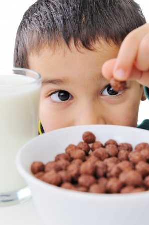 Portrait of a nice boy with cereals and milkの写真素材