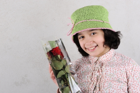 Little smiling girl with a roseの写真素材
