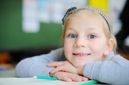 Beautiful young blonde girl in schoolの写真素材