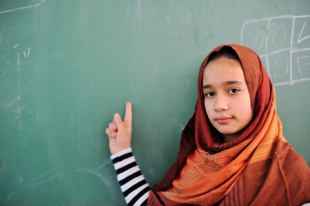 Beautiful muslmi girl in front of blackboardの写真素材