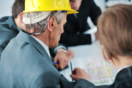 Senior executive showing future construction plans to his colleagues