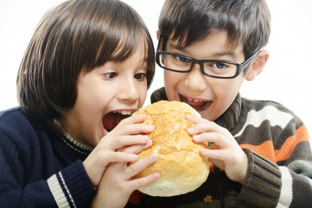 Two boys eating breadの写真素材