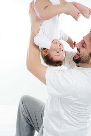 Young father playing with his little babyの写真素材