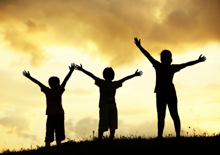 Active group of kids spending happy time on summer sunset at meadowの写真素材
