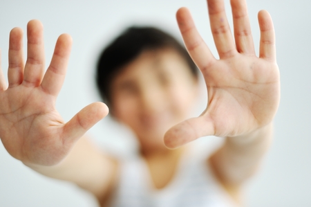 Cheerful little boy showing his empty handの写真素材