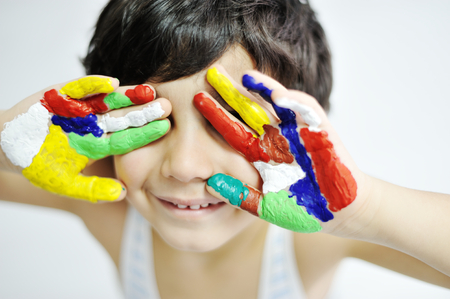 Happy kid with paints on handsの写真素材