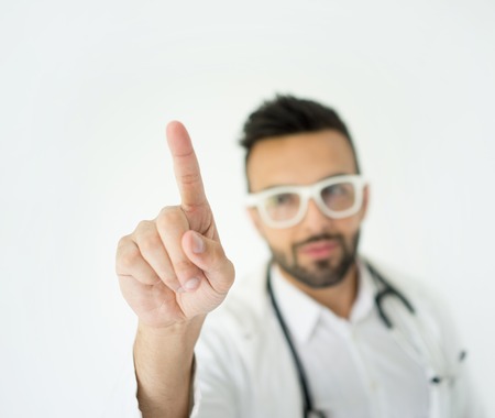 Male doctor pressing copy space with fingerの写真素材