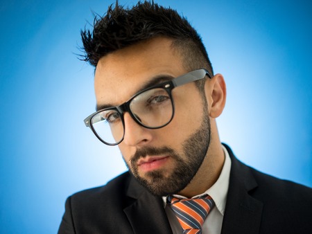 Businessman standing on blue backgroundの写真素材