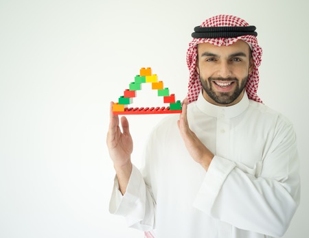 Arabic young businessman building cube houseの写真素材