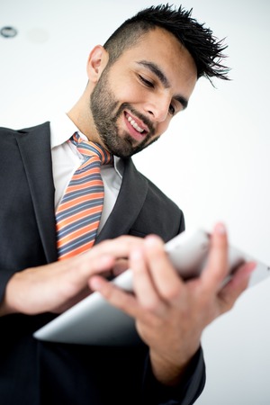 Portrait of attractive man standing with tabletの写真素材