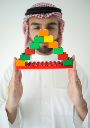 Arabic young businessman building cube houseの写真素材