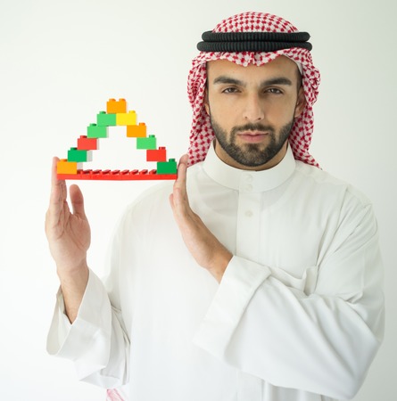 Arabic young businessman building cube houseの写真素材