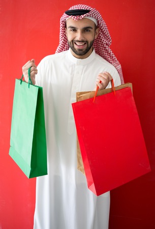 Arabic young businessman with shopping bagsの写真素材