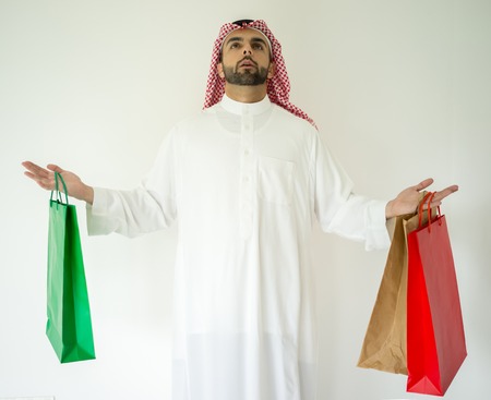 Arabic young businessman with shopping bagsの写真素材