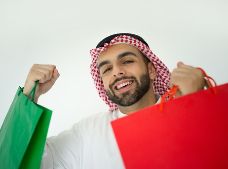 Arabic young businessman with shopping bagsの写真素材