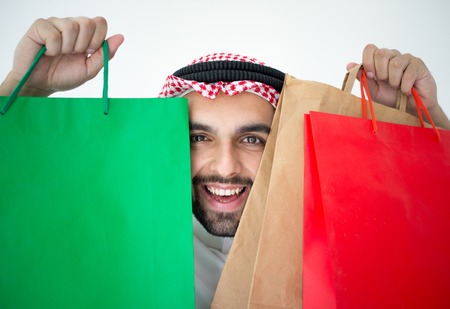Arabic young businessman with shopping bagsの写真素材
