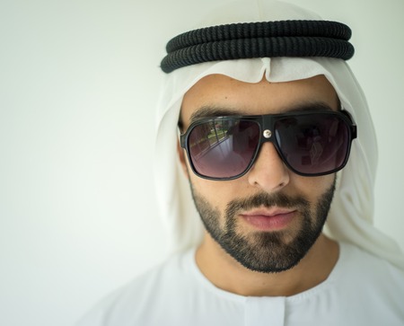 Arabic young man posing with sunglassesの写真素材